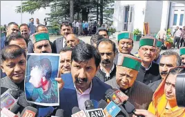  ?? DEEPAK SANSTA/HT ?? Leader of opposition Mukesh Agnihotri showing a picture of a party worker injured during the youth Congress protest outside the Vidhan Sabha, in Shimla on Monday.