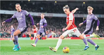  ?? — AFP photo ?? Arsenal’s midfielder Trossard (second right) shoots and scores his team third goal during the English Premier League match against Liverpool at the Emirates Stadium in London.