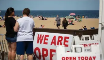  ?? Photo: Xinhua ?? Signs for a restaurant open for takeout are displayed on the boardwalk at Belmar Beach amid the COVID-19 pandemic in Belmar, New Jersey, the United States, on May 16, 2020.