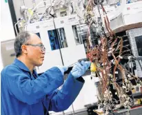  ?? REUTERS ?? Ernest Han works on an ongoing experiment to get bitumen out of oil sands at the Imperial Oil research lab in Calgary, Alta.