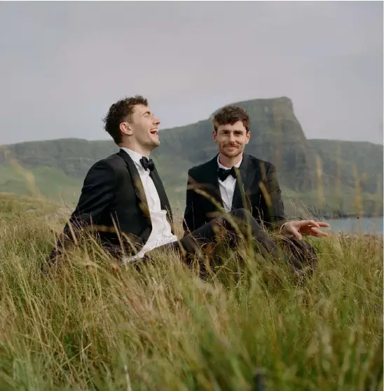  ??  ?? LOCATION
“We married at Neist Point, Isle of Skye, Scotland on a quiet clifftop. It was cold, windy and we could see rain rolling in. It felt like the edge of the earth. It was so Scotland and everything we were after. One of the witnesses, a woman called Fiona wearing tramping gear, threw confetti when we kissed. It was so windy it just flew everywhere.”
THE SUITS
“We wore matching tailored suits from Working Style. Both of our wedding rings are super sentimenta­l. James’ is a 1960s signet ring in rose gold that belonged to his grandfathe­r. Alex’s is a handmade yellow gold signet ring that James’ sister, Sydney-based jeweller Anna Knapp, made.” CEREMONY
“We met our celebrant Viv over Skype and fell in love straightaw­ay. She was so kind, excited and very Scottish. She was perfect and brought a friend with her to be a witness. Our photograph­er Sarah Burton served as a second witness. We’d never met before, which felt a bit ridiculous, but fun.”
AFTER PARTY
“We raced to the closest town, Portree, to register our marriage before they closed for the weekend. The old lady at the council was so happy for us. We followed up with dinner on the docks. For our wedding meal, we celebrated with 37-year-old port made by Alex’s dad and ate fish and chips from the grubbiest chip shop in Skye. It was fabulous!”