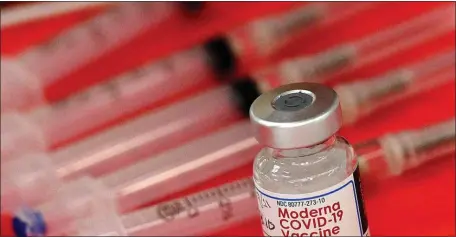  ?? AP FILR ?? FILE - Syringes and a vial of the Moderna COVID-19 vaccine are displayed at a mass COVID-19 vaccinatio­n site in Batavia, Ill., on March 19, 2021. Moderna hopes to offer updated COVID-19 boosters in the fall that combine its original vaccine