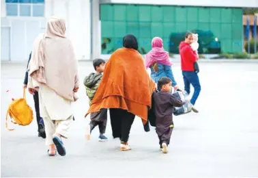  ?? SGT. GLORIA KAMENCIK/U.S. ARMY VIA AP ?? U.S.-affiliated Afghans arrive at the Pristina Internatio­nal Airport in Kosovo on Oct. 16.