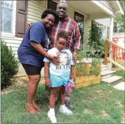  ??  ?? Monica and Michael Boggus pose before their home with their daughter MaKyla, whose photo will look down on the streets of New York City this September. (Catoosa News photo/Tamara Wolk)