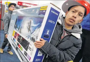  ?? AP PHOTO ?? Shoppers wait to make purchases at electronic­s chainstore Best Buy on Black Friday in Dartmouth, Mass. on Friday, Nov. 24, 2017.