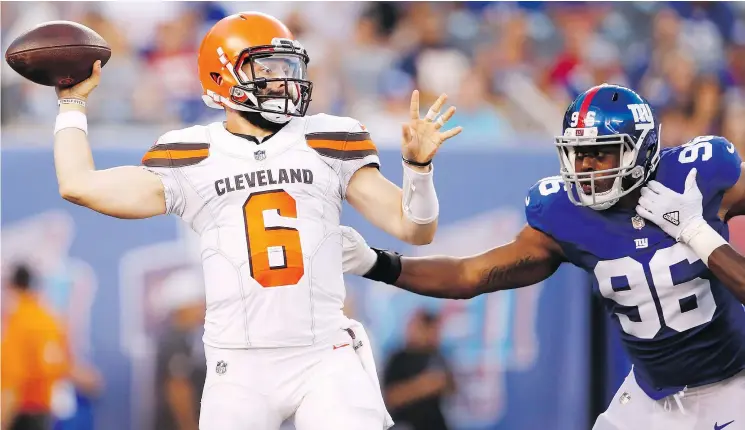  ?? — PHOTOS: ADAM HUNGER/THE ASSOCIATED PRESS ?? Cleveland quarterbac­k Baker Mayfield looked fairly sharp against Kareem Martin and the Giants in his NFL pre-season debut Thursday in East Rutherford, N.J. The Heisman Trophy winner completed 11 of 20 passes for 212 yards and two touchdowns in a 20-10 Browns victory.