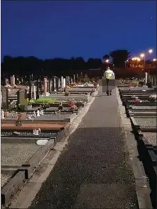  ??  ?? A Garda on patrol at night in Sligo cemetery.