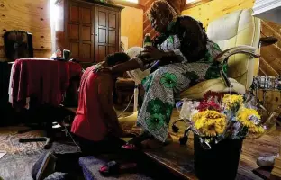  ?? ?? Pastor Shetigho Nakpodia prays for Alex Menuzo, 50, in June at the East Side church.