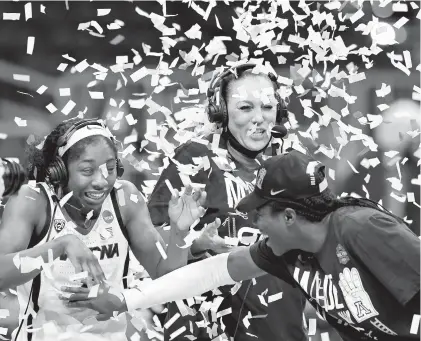  ?? ELSA/GETTY ?? Aari McDonald and coach Adia Barnes of the Arizona Wildcats are showered with confetti after a 66-53 victory over the Indiana during the Elite Eight round of the NCAA Women’s Basketball Tournament at the Alamodome on March 29, 2021 in San Antonio, Texas.