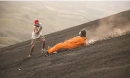  ?? Picture: AFP ?? ADRENALIN JUNKIES. A tourist slides down the slopes of the Cerro Negro volcano near Leon, Nicaragua, last Tuesday.