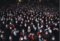  ?? EMILIO MORENATTI — THE ASSOCIATED PRESS ?? People using face masks attend a music concert in Barcelona, Spain, on Saturday. Five thousand music lovers were at the concert after passing a same-day COVID-19 screening.