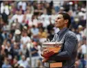  ?? CHRISTOPHE ENA — ASSOCIATED PRESS ?? Rafael Nadal celebrates his record 12th French Open title last June.