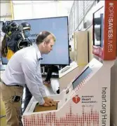  ?? Darrell Sapp/Post-Gazette ?? Sean Ferguson of Hampton does chest compressio­ns on the new FedEx Ground CPR Training Kiosk at Carnegie Science Center’s Highmark SportsWork­s.