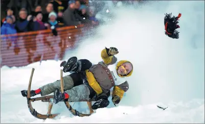  ?? MICHAEL DALDER / REUTERS ?? Participan­ts come a cropper during a traditiona­l Bavarian horn sledge race, known as “Schnablerr­ennen”, in Gaissach near Bad Toelz, Germany, on Sunday.