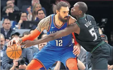  ?? [AP PHOTO/JIM MONE] ?? Oklahoma City Thunder's Steven Adams, left, keeps the ball away from Minnesota Timberwolv­es' Gorgui Dieng during Tuesday night's game in Minneapoli­s.