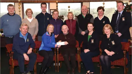  ??  ?? Joe Geaney, Kerry Linen Services, (seated centre) presenting first prize in the Kerry Linen Services Mixed competitio­n to winners Denis and Christine Carroll with Amy Arthur Lady Captain, Breda Duggan President (back from left) Gerard O’Meara and...