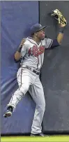  ??  ?? GETTY IMAGES Atlanta’s Eury Perez makes a catch in left field to retire Jean Segura in the second inning.