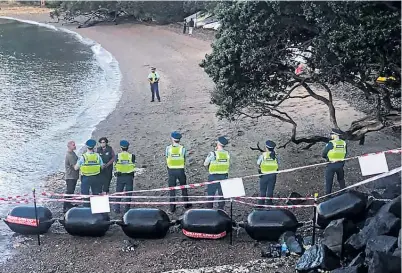  ?? Photo / Protect Putiki ?? Police officers form a barrier at Putiki Bay, Kennedy Point, yesterday.