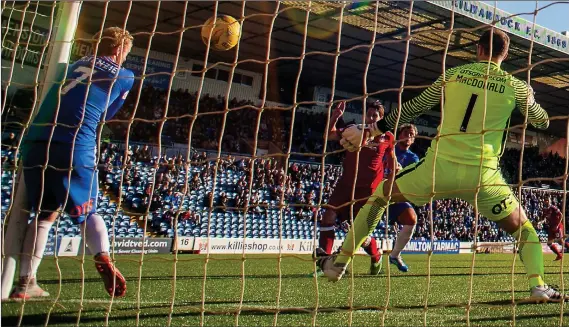  ??  ?? MADDISON BOUNTY: Taylor hammers the ball between Killie keeper MacDonald and team-mate McKenzie to put Dons 3-0 up, the goal coming from a Maddison corner