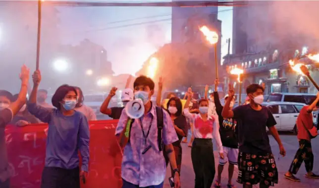  ?? Agence France-presse ?? Protesters hold up the three-finger salute during a demonstrat­ion against the military coup in Yangon, Myanmar, on Thursday.