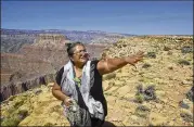  ?? TOM BEAN / AP ?? Renae Yellowhors­e, a spokespers­on for Save the Confluence, promotes the aerial tram at Confluence Overlook on the East Rim of the Grand Canyon on Navajo Nation west of The Gap, Ariz.