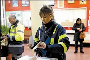  ?? AP/GONZALO ARROYO ?? A postal worker casts her vote Thursday in the Catalan regional election at a polling station in Tarragona, Spain.