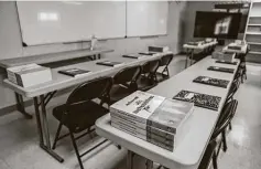  ?? Sergio Flores / Washington Post contributo­r ?? Textbooks and notebooks line tables inside a classroom at the facility. President Joe Biden pledged to undo Trump’s immigratio­n policies.