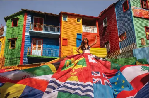  ?? HANDOUT/GCBA VIA AFP ?? Handout photo released by the Buenos Aires City Government shows Argentine actress Florencia de la V wearing the Amsterdam Rainbow Dress at Caminito street in La Boca neighbourh­ood in Buenos Aires, in the framework of the Equal Rights Coalition (ERC) Internatio­nal Congress. Buenos Aires is the first Latin American city to receive the emblematic dress for the defence of LGBTIQ+ rights.