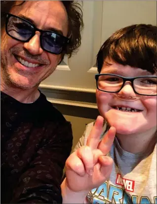  ??  ?? Downey Jr with youngster Aaron Hunter, who is battling terminal illness