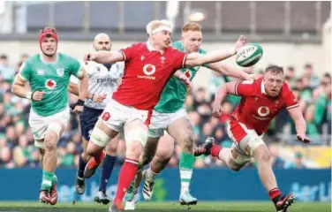  ?? Agence France-presse ?? ↑ Wales’ Aaron Wainwright (centre left) and Ireland’s Ciaran Frawley (centre right) compete for a loose ball during their Six Nations match in Dublin.