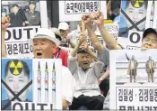  ?? JULIE YOON / AP ?? South Korean protesters with defaced portraits of North Korean leader Kim Jong Un shout slogans during a rally in Seoul, South Korea, on Friday