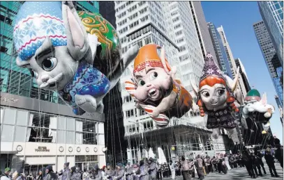  ?? Tina Fineberg ?? The Associated Press The Fleck, Bjorn, Jojo, and Hugg balloons travel New York’s Sixth Avenue during the 92nd annual Macy’s Thanksgivi­ng Day Parade on Thursday. The temperatur­e was 21 degrees at the start of the parade, with sustained winds of up to 20 mph and gusts to 30 mph.