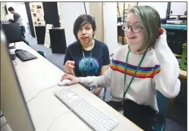  ?? NWA Democrat-Gazette/DAVID GOTTSCHALK ?? Ivy Shacklett (right) and Zoe Najera, both seventh-grade students in Brittany Berry’s class at Helen Tyson Middle School, edit a video Friday at the school in Springdale. The students are working on a video presentati­on for the Tontitown Historical Museum.