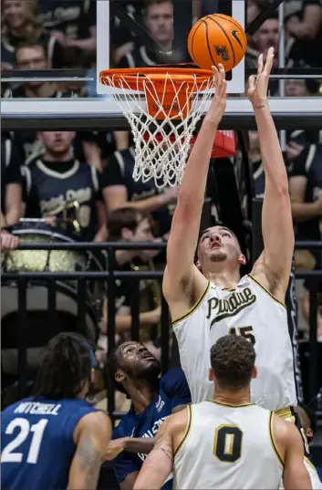  ?? Michael Hickey/Getty Images ?? Purdue center Zach Edey lays the ball in Saturday against Penn State in West Lafayette, Ind. Edey had 30 points and 20 rebounds in a 95-78 victory.