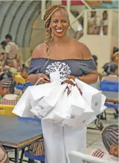  ??  ?? Dr Janice Johnson Dias is all smiles as she gets ready to distribute menstrual kit to the students at the Invest In Girls Summit held at St. James High in partnershi­p with Herflow Foundation on April 15, 2019.