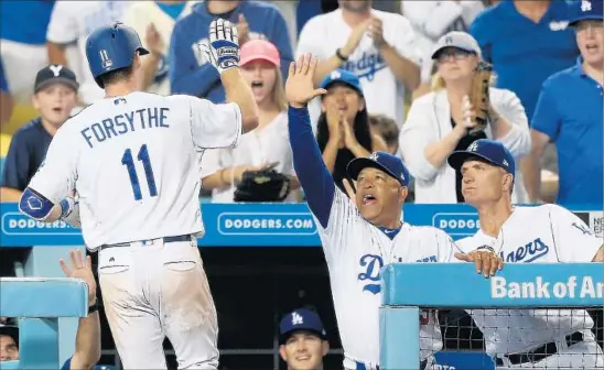  ?? Robert Gauthier Los Angeles Times ?? MANAGER DAVE ROBERTS high-fives Logan Forsythe after the second baseman homered against the Diamondbac­ks on July 6 at Dodger Stadium.