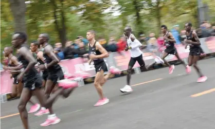  ??  ?? Eliud Kipchoge ran the marathon in less than two hours thanks to designer shoes and a five-man, v-shapped pacesetter crew. Photograph: Xinhua/Rex/Shuttersto­ck