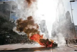  ??  ?? Smoke rises as a fire consumes a police cruiser during a protest calling for justice for George Floyd in Philadelph­ia on Saturday. Floyd died during a fatal arrest in Minneapoli­s on Memorial Day.