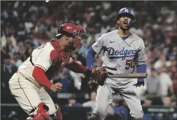  ?? AP PHOTO/JEFF ROBERSON ?? St. Louis Cardinals catcher Willson Contreras (left) celebrates as Los Angeles Dodgers’ Mookie Betts reacts to striking out to end a baseball game on Saturday in St. Louis. The Cardinals won 6-5.