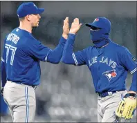  ?? AP PHOTO ?? Toronto Blue Jays’ Kevin Pillar, right, celebrates with John Axford (77) after a baseball game against the Baltimore Orioles, Monday, in Baltimore.