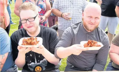  ??  ?? Competitor­s brave the hot wings challenge by Southport firm Wingbox at Southport Food and Drink Festival