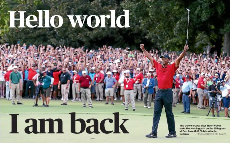  ?? TIM BRADBURY/GETTY IMAGES ?? The crowd erupts after Tiger Woods sinks the winning putt on the 18th green at East Lake Golf Club in Atlanta, Georgia.