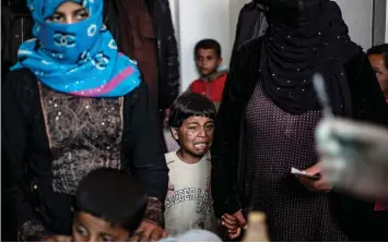  ??  ?? A Syrian boy cries as he waits to receive treatment for leishmania­sis skin disease at a health centre.