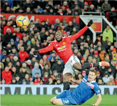  ?? AP ?? Manchester United’s Romelu Lukaku (left) watches his shot on goal as Stoke City’s Kevin Wimmer looks on during the English Premier League soccer match between Manchester United and Stoke City at Old Trafford in Manchester, England on Monday. —
