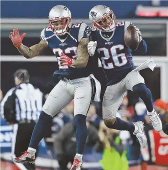  ?? STAFF PHOTO BY MATT WEST ?? SECONDARY SURGE: Cornerback Logan Ryan (26) and safety Patrick Chung celebrate Saturday night during the Pats’ win against the Texans.