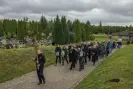  ?? Anna Liminowicz/The Guardian ?? Mourners escort Jan Ledwoń’s ashes to the grave in Elbląg, northern Poland. Photograph: