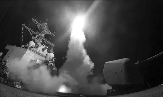  ?? MASS COMMUNICAT­ION SPECIALIST 3RD CLASS FORD WILLIAMS / U.S. NAVY VIA AP ?? In this image provided by the U.S. Navy, the guided-missile destroyer USS Porter launches a tomahawk land attack missile April 7 in the Mediterran­ean Sea. The target was an airfield in Syria.