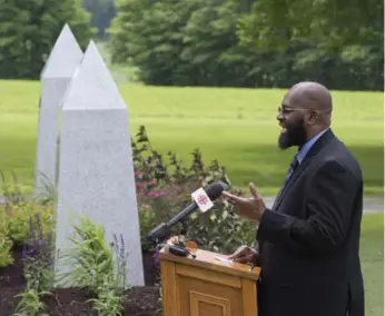  ?? JACQUES BOISSINOT PHOTOS/THE CANADIAN PRESS ?? Adam Diakite speaks at the inaugurati­on of a Muslim section at the cemetery in Saint-Augustin-de-Desmaures.