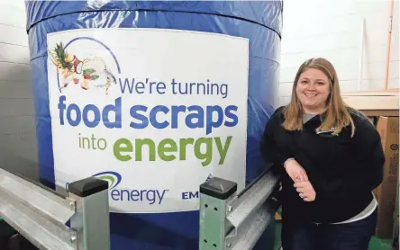  ?? BARBARA J. PERENIC/COLUMBUS DISPATCH ?? Dublin Jerome High School environmen­tal sciences teacher Ashley Dulin-smith stands by a storage tank for the Grind2ener­gy machine that converts the school’s food waste into natural gas. Dublin Jerome is the first K-12 school in North America to receive the machine.