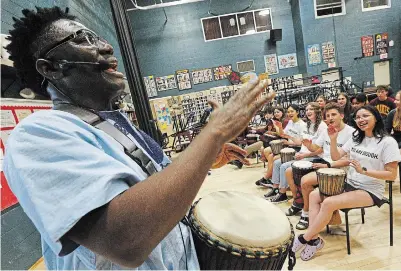  ?? CLIFFORD SKARSTEDT EXAMINER ?? Babarinde Williams leads a drumming workshop for students titled Mind and Body Wellness as
St. Peter Secondary School hosts a mental-health symposium on Tuesday.